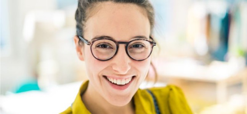 A smiling woman with glasses
